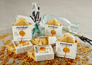 organic lemongrass calendula soap by potager soap co with bottle of lavender sprigs and lcalendula petals