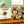 Stack of soap bars with 'Potager Soap Co.' packaging on a wooden surface.