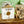 Stack of soap bars from Potager Soap Co. on a wooden surface with a green background.