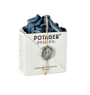 Bar of Lavender Charcoal Potager Soap with swirls of charcoal wrapped with letterpress paper tied with twine and sealed with wax