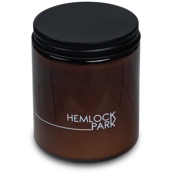 Potager Soap Co. 8 oz Lychee Mangosteen candle in an amber glass jar with a matte black metal lid