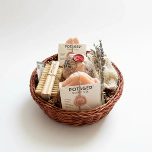 Potager Soap Co. artisan bath gift basket with handcrafted soap bars, bamboo brush, wash mitt, and dried lavender.