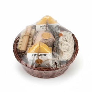Potager Soap Co. artisan bath gift basket with handcrafted soaps, bamboo brush, wash mitt, and dried lavender.