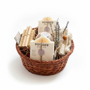 Potager Soap Co. artisan bath gift basket with handcrafted soaps, bamboo brush, wash mitt, and dried lavender.