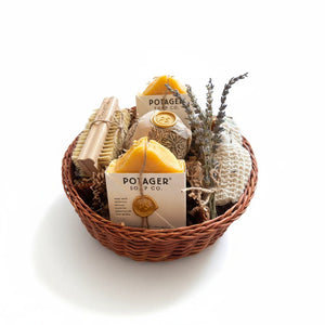 Potager Soap Co. artisan bath gift basket featuring natural soap bars, bamboo brush, wash mitt, and dried lavender.