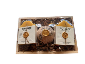 Potager Soap Co. artisan soap gift set with two lemongrass calendula bars and a bath bomb in a rustic wooden crate.