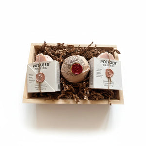 Potager Soap Co. artisan soap gift set with two bars and a bath bomb in a rustic wooden crate with wax seals.
