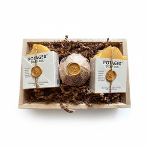Potager Soap Co. artisan soap gift set featuring two lemongrass calendula bars and a bath bomb in a wooden crate.