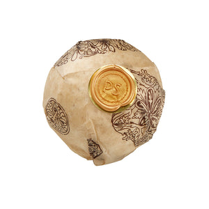 Potager Soap Co. botanical bath bomb sphere wrapped in patterned paper with a gold wax seal on a white background.
