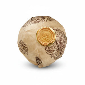 Potager Soap Co. botanical bath bomb sphere wrapped in patterned paper with a signature gold wax seal.