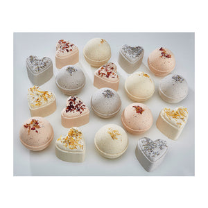 Potager Soap Co. heart-shaped and round botanical bath bombs topped with dried flower petals on a white background.