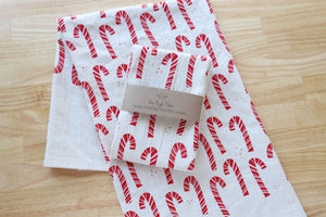 Potager Soap Co. handprinted natural cotton kitchen towel featuring a festive red candy cane pattern for Christmas.