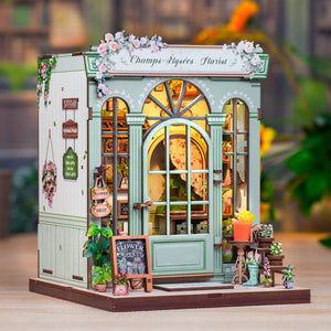 Potager Soap Co. DIY miniature Champs-Élysées florist book nook kit with pastel green walls and glowing LED lights.