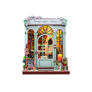 Potager Soap Co. Champs-Élysées Florist DIY book nook kit with pastel green facade, floral decor, and warm LED lighting.
