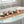 Potager Soap Co. egg-shaped bath bombs in recycled cartons on a wooden bath tray with lavender and a lit candle.