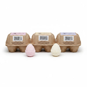 Potager Soap Co. egg-shaped bath bombs in recycled paper cartons with pink and white fizzing bath eggs in front.