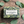 Potager Soap Co. Eucalyptus Everyday bar soap in green patterned packaging with eucalyptus leaves on wood background