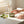 Hands holding a Potager Soap Co. Eucalyptus Everyday bar soap wrapped in green botanical patterned paper on a counter.