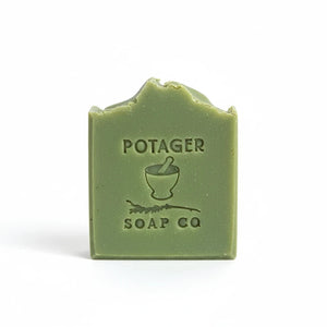 Potager Soap Co. handcrafted eucalyptus mint bar soap with a stamped mortar and pestle logo on a sage green surface.