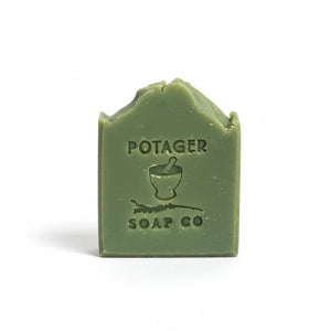 Potager Soap Co. handcrafted eucalyptus mint bar soap in a natural green shade with a stamped logo on a white background