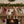 Potager Soap Co. pair of rustic reindeer ornaments with carved wood heads and faux fur bodies on a wooden mantelpiece.