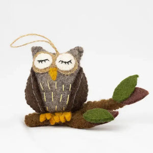 Potager Soap Co. handmade felt owl ornament perched on a branch, crafted from natural wool in brown and green tones.