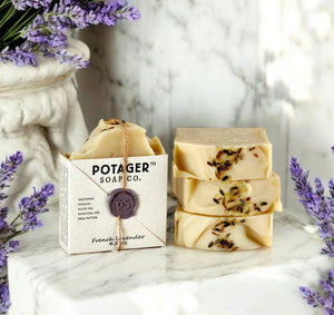 Potager Soap Co. French Lavender organic bar soap with dried lavender buds and wax seal on a marble surface.