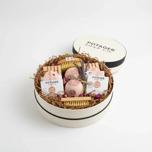 Potager Soap Co. handcrafted gift set in a white linen hat box with soap bars, bath bombs, and natural brushes.