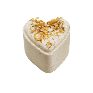 Potager Soap Co. heart-shaped bath bomb topped with dried yellow calendula petals on a white background