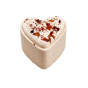 Potager Soap Co. heart-shaped bath bomb in pale pink with scattered dried flower petals on top.