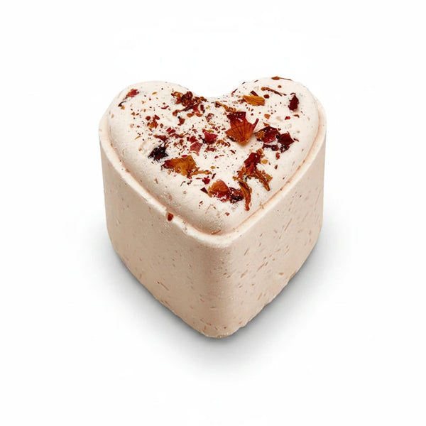 Potager Soap Co. heart-shaped bath bomb in pale pink with scattered dried flower petals on top