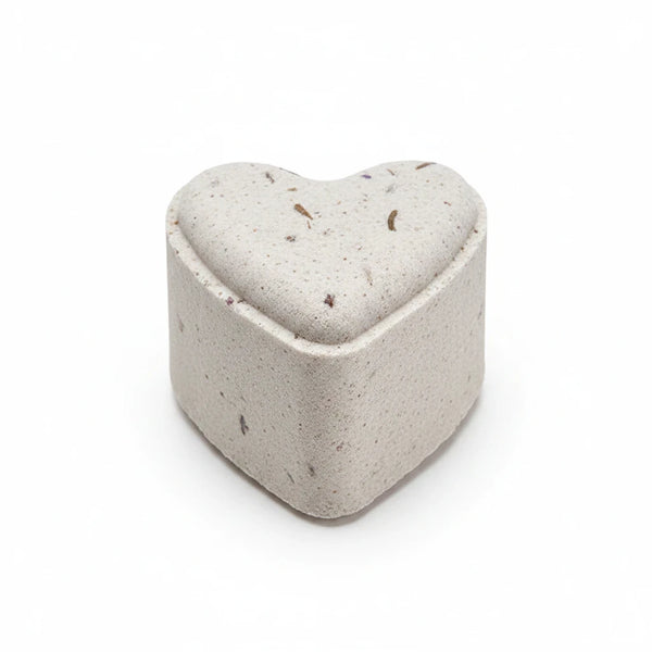 Potager Soap Co. heart-shaped French lavender bath bomb with dried botanical flecks on a white background
