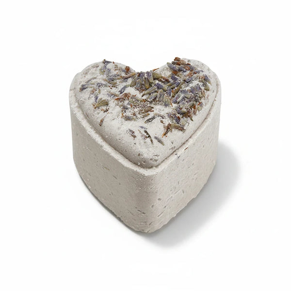 Potager Soap Co. heart-shaped French lavender bath bomb topped with dried botanical flowers on a white background
