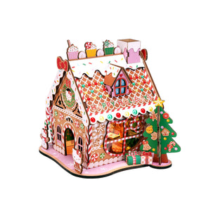Potager Soap Co. Hello Kitty wooden gingerbread house DIY craft kit with festive holiday decorations and LED lights.
