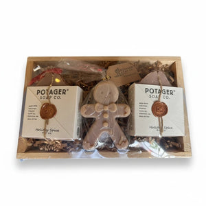 Potager Soap Co. holiday gift set with two Holiday Spice soap bars and a gingerbread man soap in a rustic wood tray.