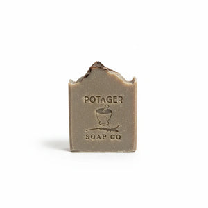 Potager Soap Co. Holiday Spice artisan soap bar with a rustic textured top and embossed brand logo on a white background