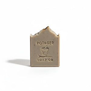 Potager Soap Co. Holiday Spice artisan soap bar with embossed logo, featuring a rustic brown tone and textured top.
