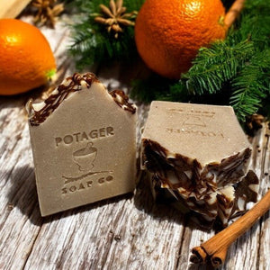 Potager Soap Co. Holiday Spice organic bar soap with a rustic dark swirl design, orange, and cinnamon sticks.