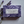 Potager Soap Co. Everyday Lavender bar soap wrapped in purple paper with botanical patterns next to lavender sprigs.