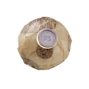 Potager Soap Co. lavender bath bomb wrapped in patterned paper with a signature purple wax seal.