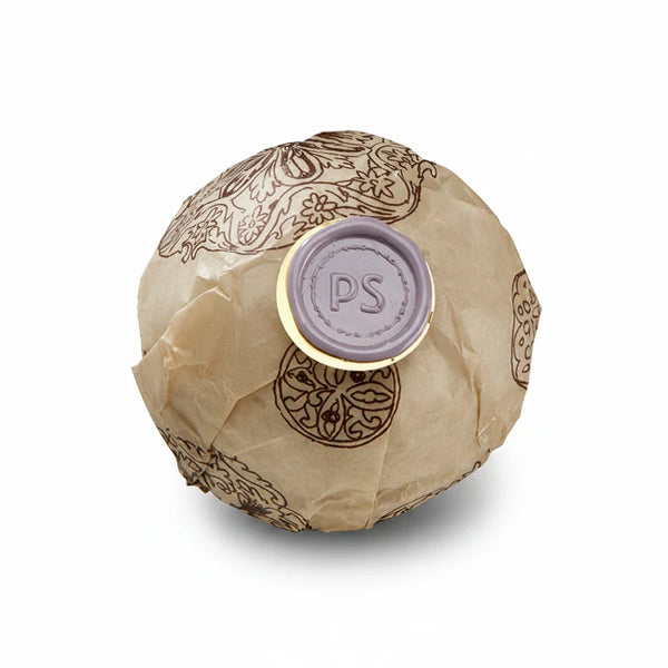Potager Soap Co. lavender bath bomb wrapped in patterned paper with a signature purple wax seal
