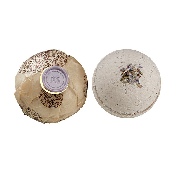 Potager Soap Co. lavender bath bomb with dried botanicals next to one wrapped in patterned paper with a wax seal