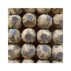 Potager Soap Co. lavender bath bombs wrapped in patterned paper with signature wax seals arranged in a box