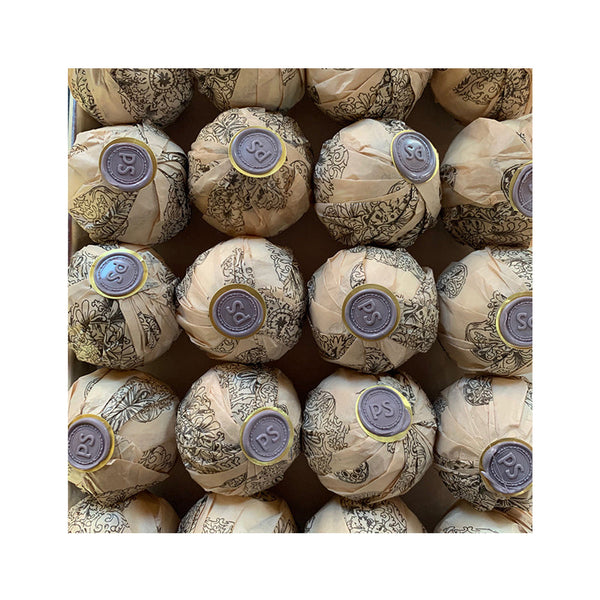 Potager Soap Co. lavender bath bombs wrapped in patterned paper with signature wax seals arranged in a box