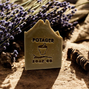 Potager Soap Co. lavender and patchouli botanical bar soap with a rustic texture, displayed with dried lavender sprigs.
