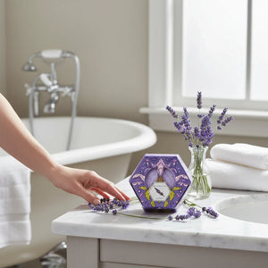 Potager Soap Co. BAUDELAIRE lavender honey soap bar in a decorative hexagonal box on a marble bathroom vanity.