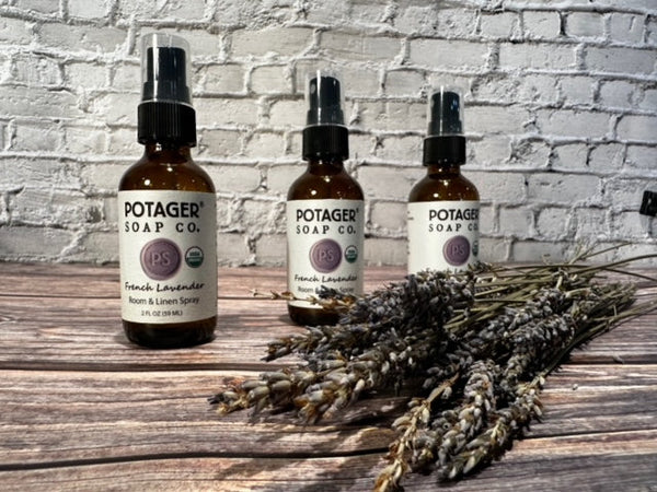 Three Potager Soap Co. amber glass bottles of organic French Lavender room and linen spray with dried lavender stems.