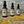 Three Potager Soap Co. amber glass bottles of organic lemongrass room and linen spray on a rustic wooden surface.
