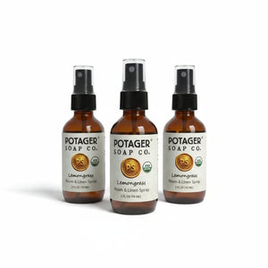 Three Potager Soap Co. amber glass bottles of organic lemongrass room and linen spray with black spray nozzles.