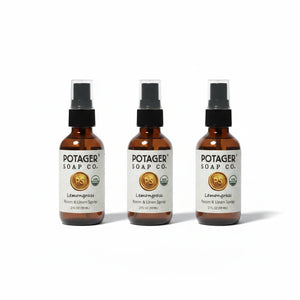 Three Potager Soap Co. Lemongrass Room and Linen Spray bottles in amber glass with black spray nozzles.
